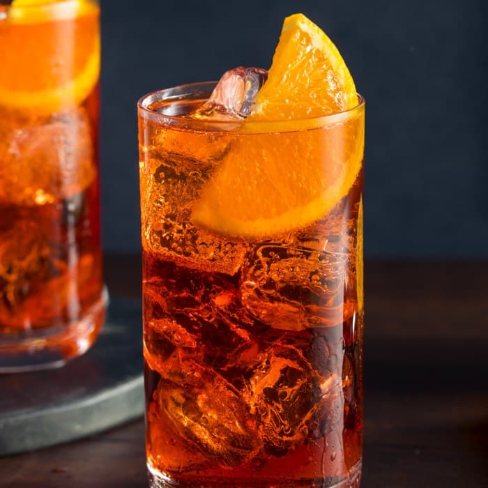Americano cocktail in collins glass with orange twist