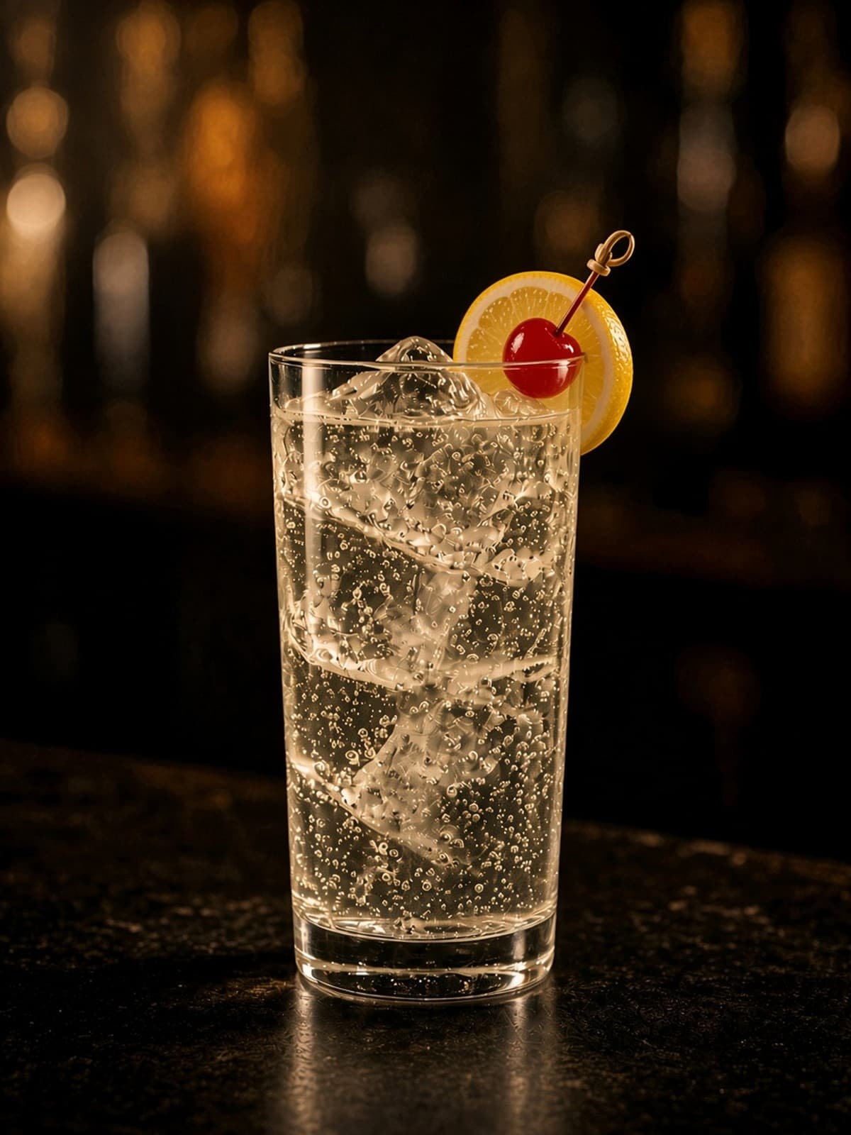 Tom Collins cocktail in collins with lemon wheel